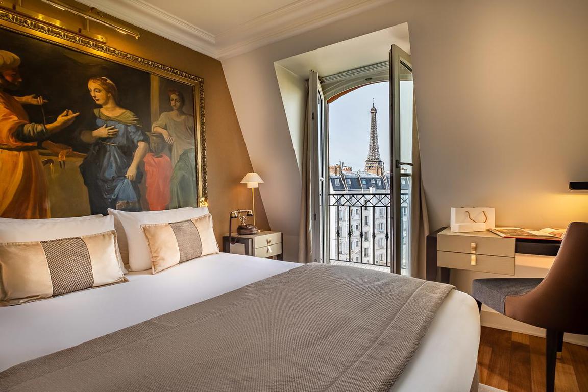 Le Walt Hotel is known for its luxury! This room has a lovely Juliette balcony view of the Eiffel Tower