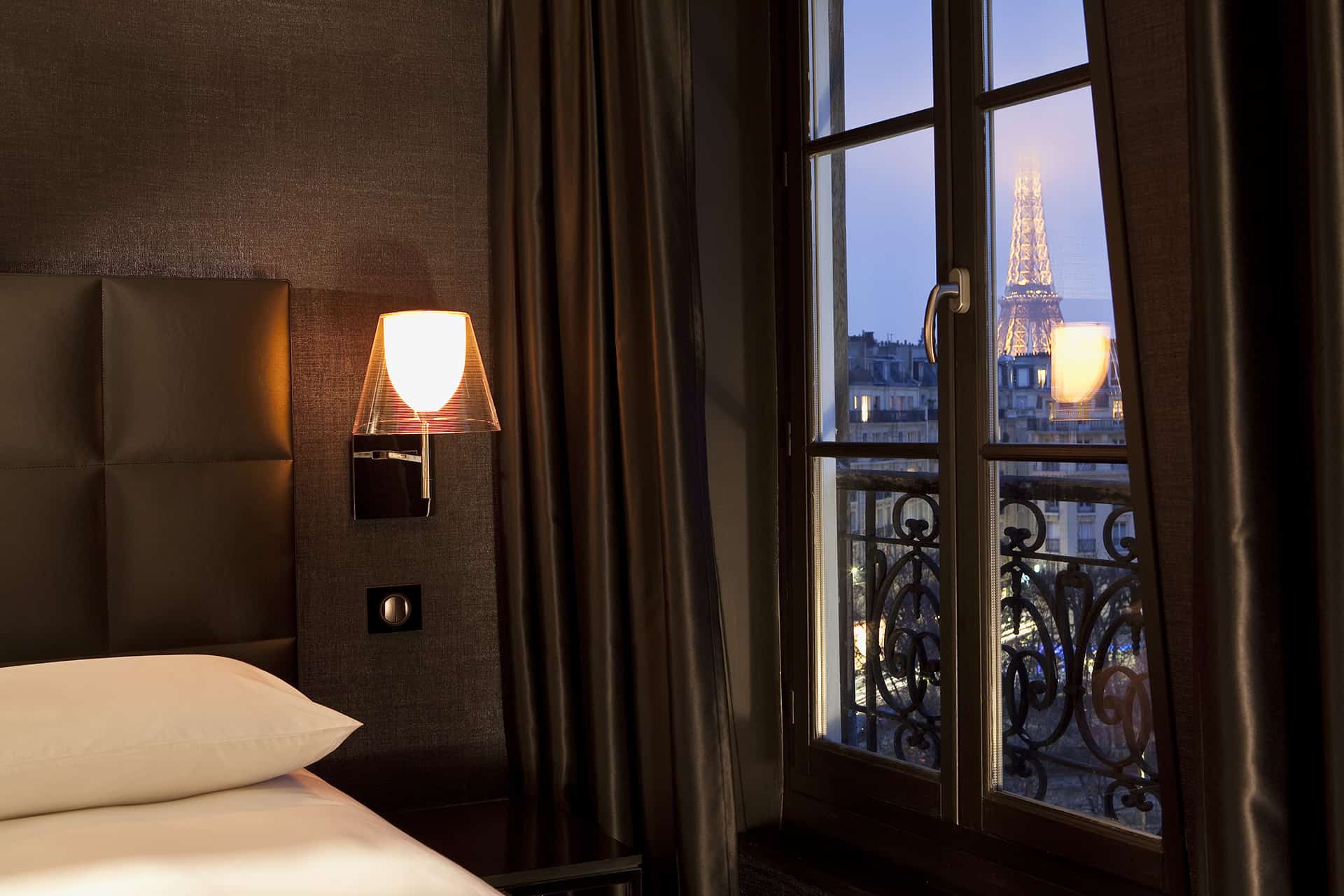 First Hotel Paris offers balcony Eiffel Tower views. The room is decorated in dark browns and looks cozy and comfortable. 