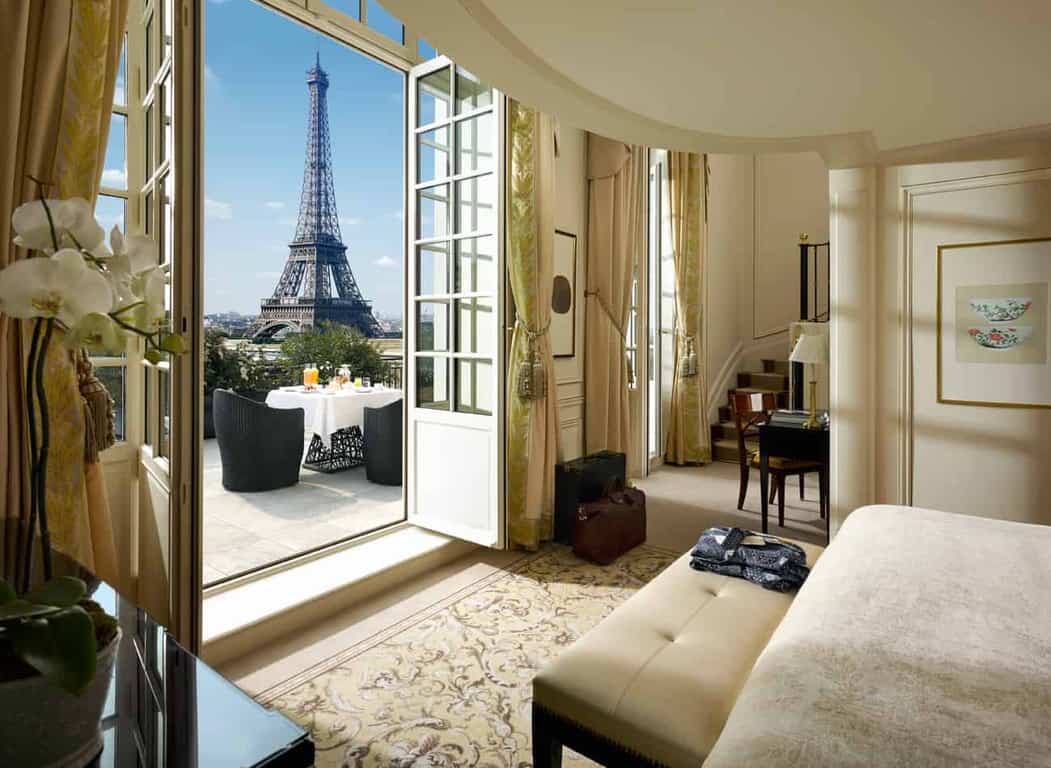 Shangri-La Hotel Paris room with the balcony doors open to show that this is one of the best Paris hotels with balcony views of the Eiffel Tower. 