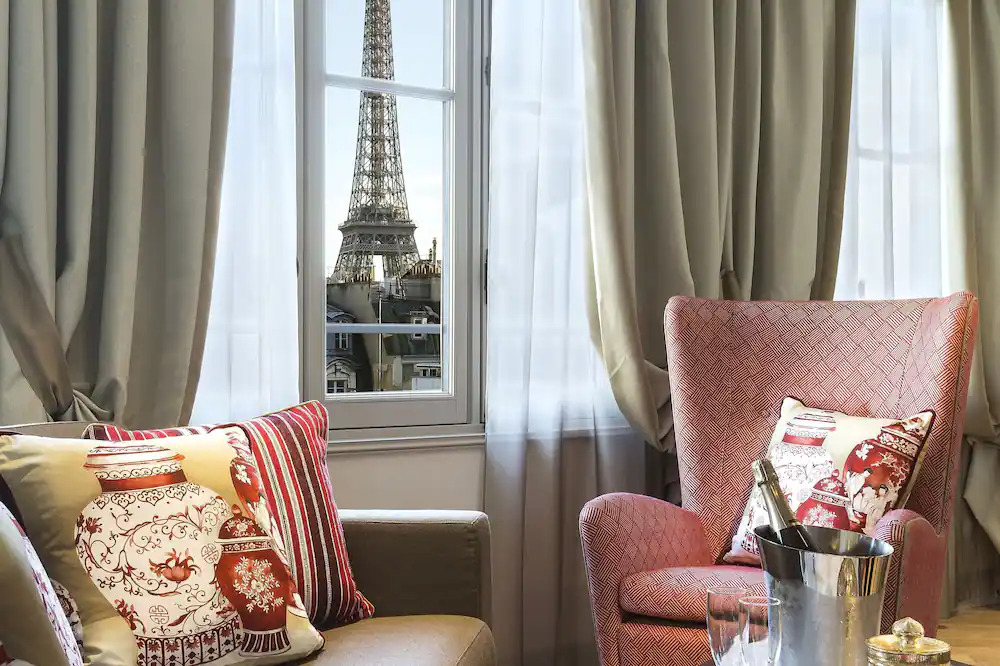 View of the Eiffel Tower from the sitting area of a hotel room in La Clef Tour Eiffel