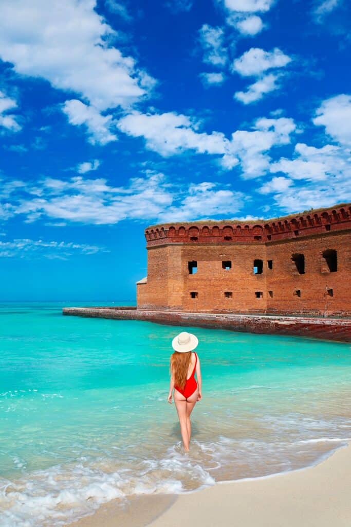 a girl in red swimsuit posing in front of dry Tortugas Natonal Park