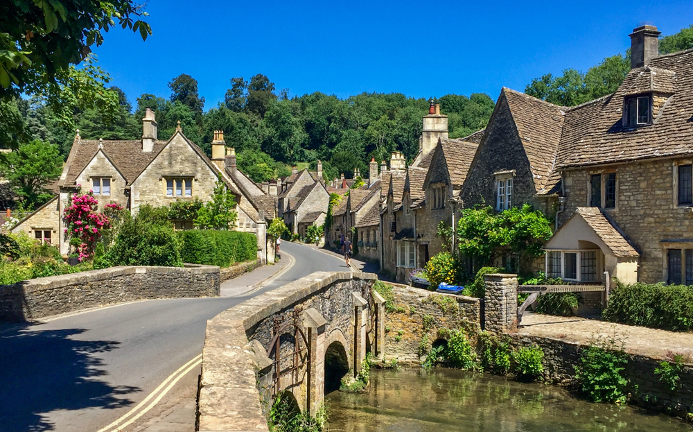 Castle Combe, Cotswolds showing the bridge and the houses off behind it. 