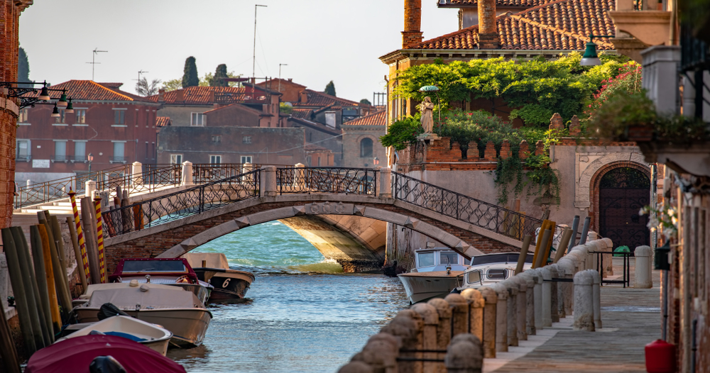 a view of the small neighborhood of Dorsoduro in Venice with a bridge
