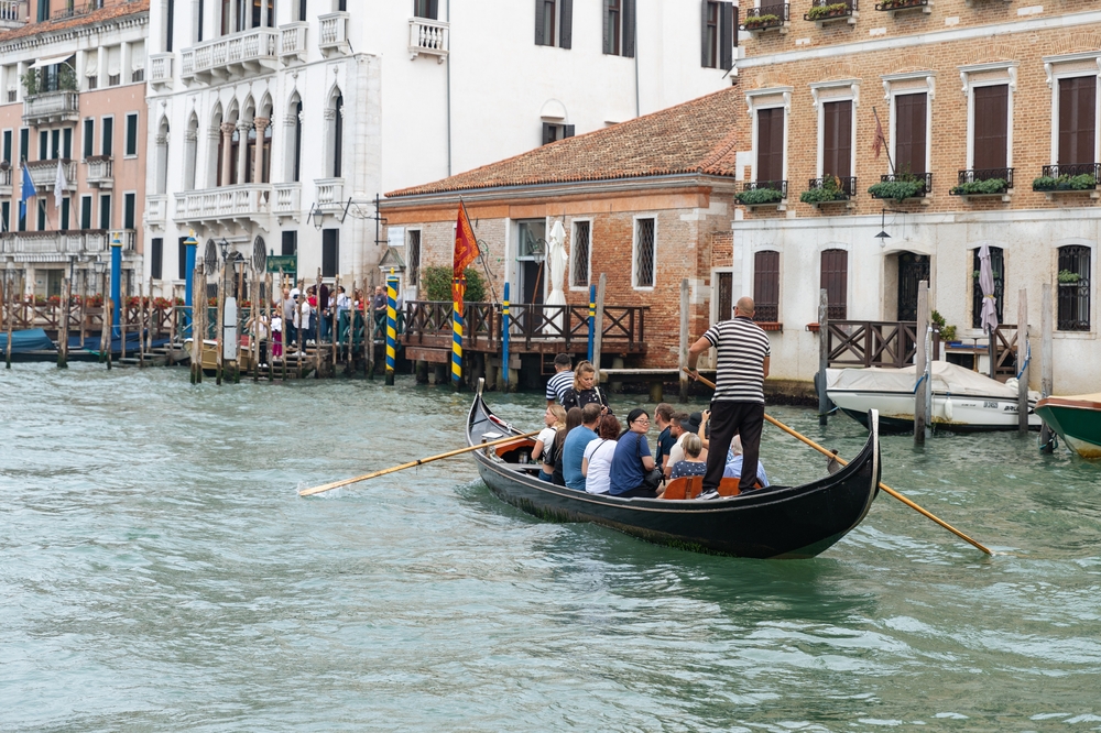 a locals using the traghetto service to get across the canal