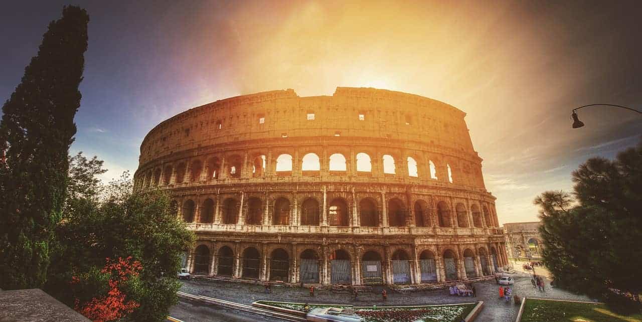 coliseum in rome at sunrise with people in foreground