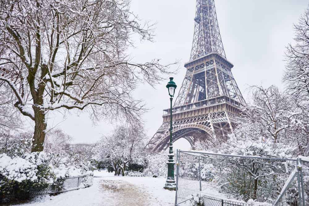 Eiffel Tower and park covered in snow during winter in Paris