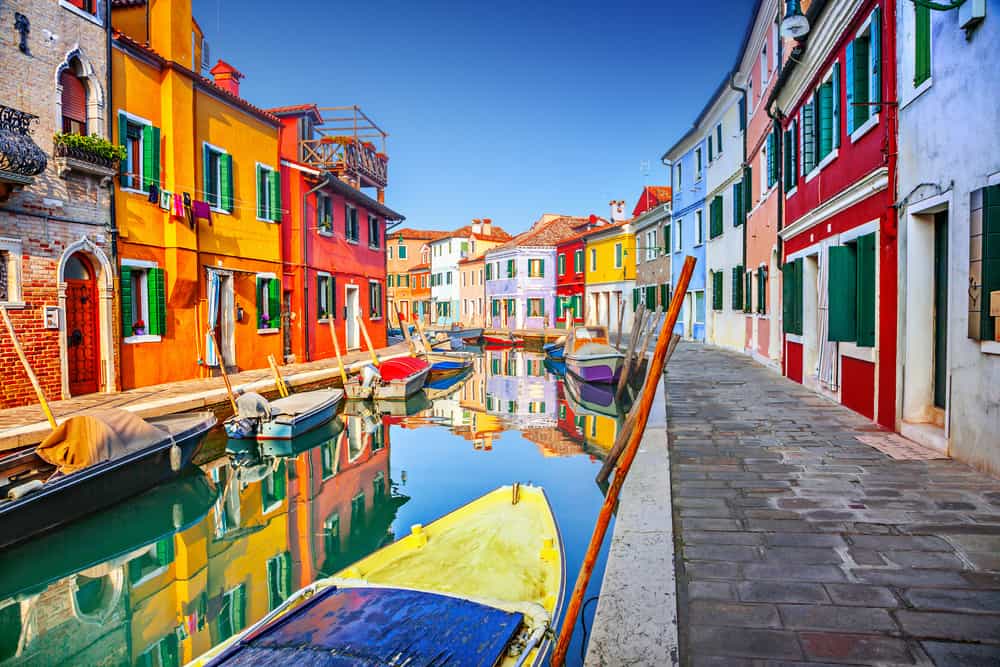The gorgeous river and fun buildings make a colorful background for any Italy honeymoon