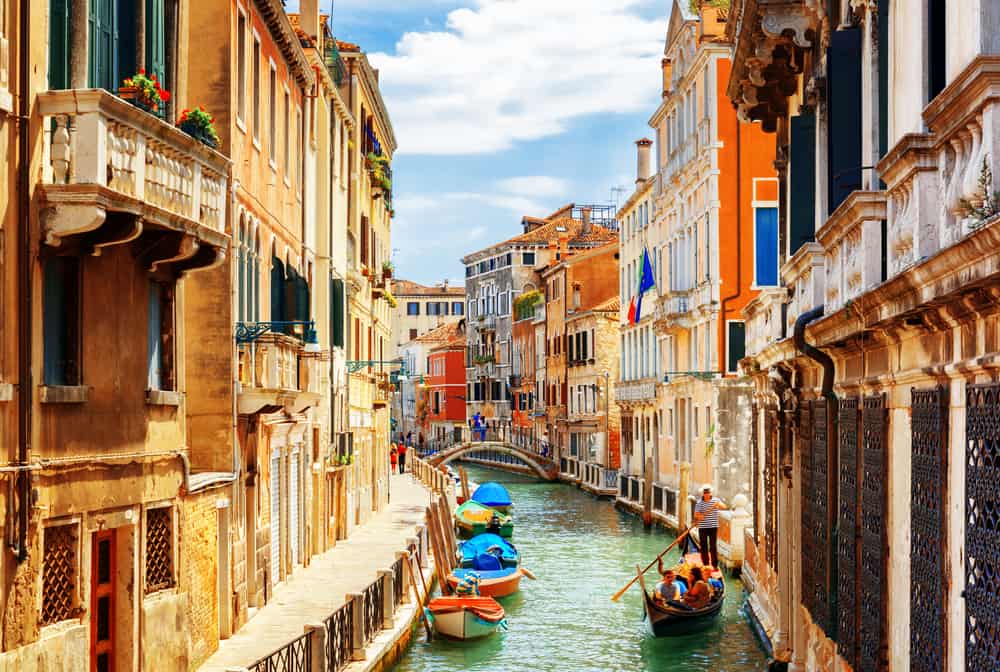 Venice is known for its close buildings that tower over gorgeous river pathways.