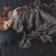 laying down with a weighted blanket in bed | anxiety blanket