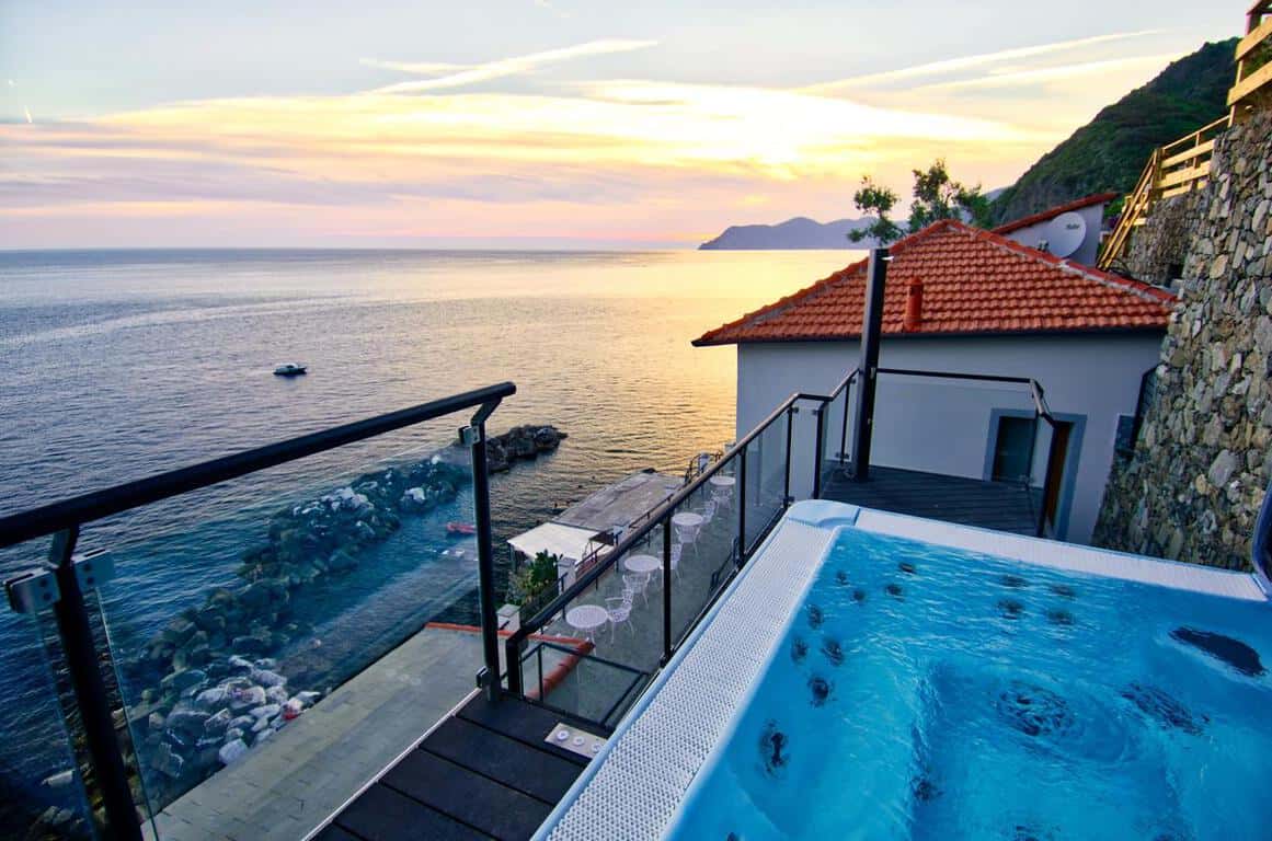 View of the sunset over the water from the hot tub at Crêuza de mä an option for where to stay in Cinque Terre.