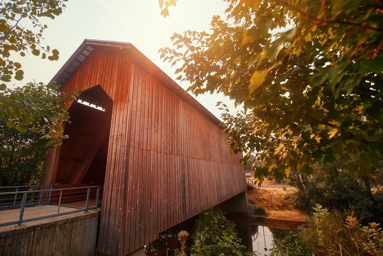 Sunny day at a historic, red covered bridge in Cottage Grove.