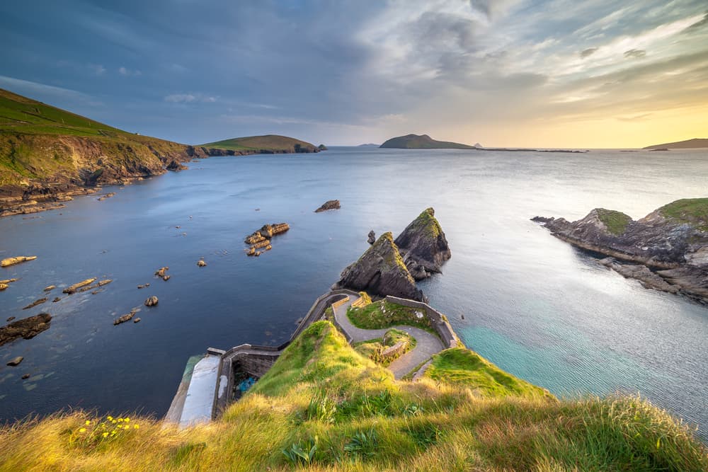 Sunset at the Dunquin Pier on the Dingle Peninsula with epic rock formations and sea views in Ireland.