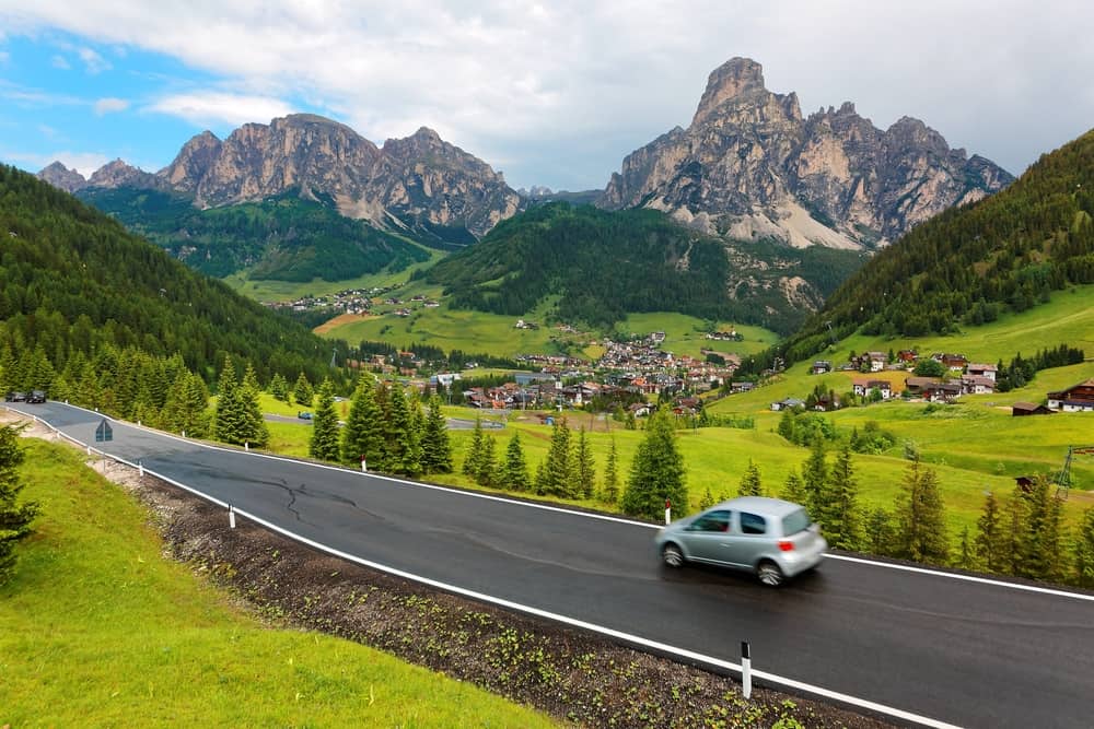 Car driving on a road in a mountain valley.