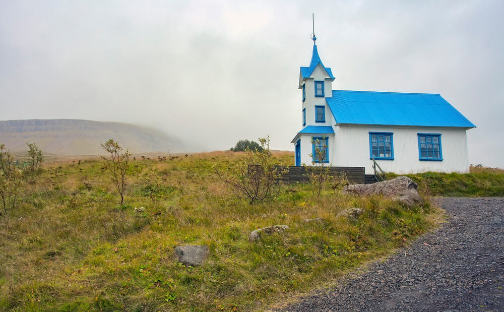 Kirkjubaer Church is a pretty pastel blue church in Iceland 