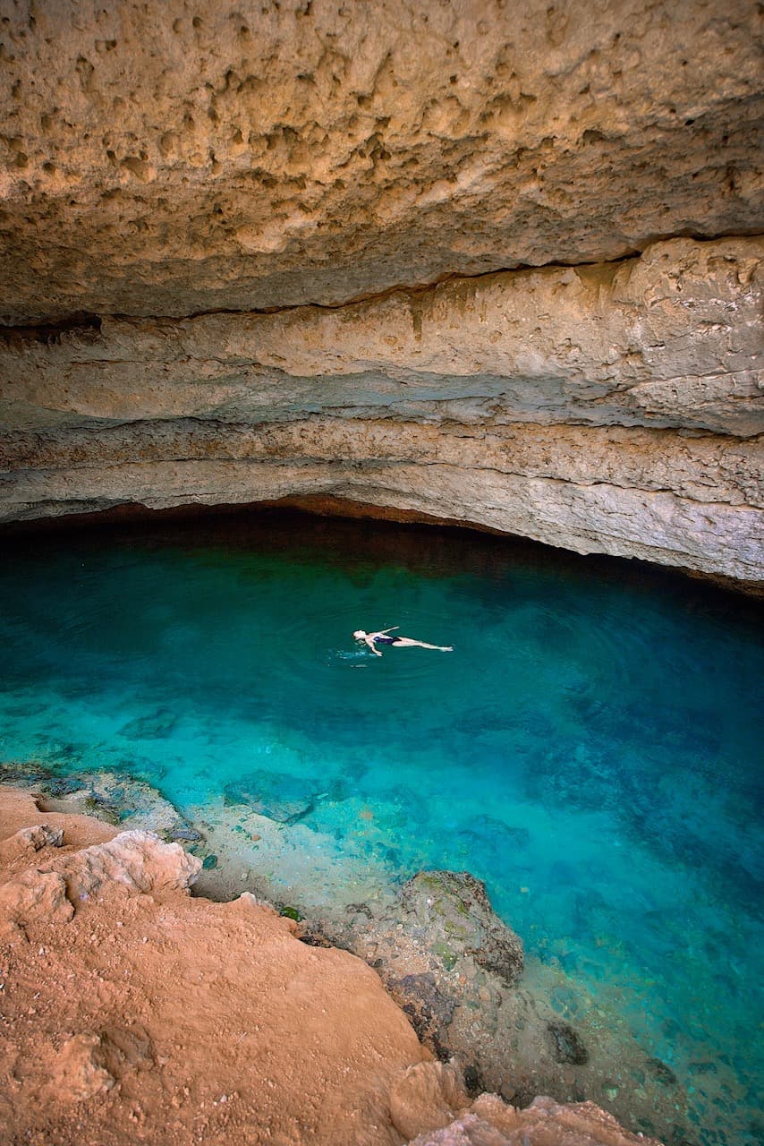 Swimming in the hidden cave area of Bimmah Sinkhole in Oman