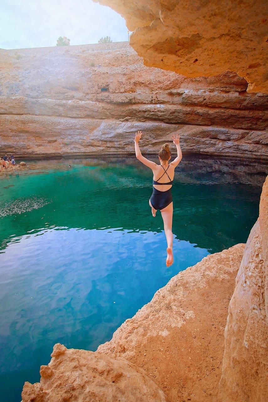 Jumping off the cliffs around Bimmah Sinkhole in Oman