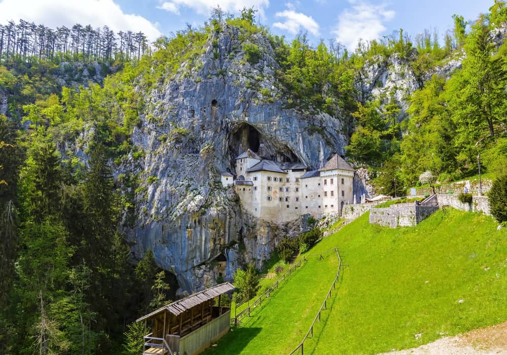 visit the world largest cave castle Predjama Castle for a change of pace when visiting castles in Europe