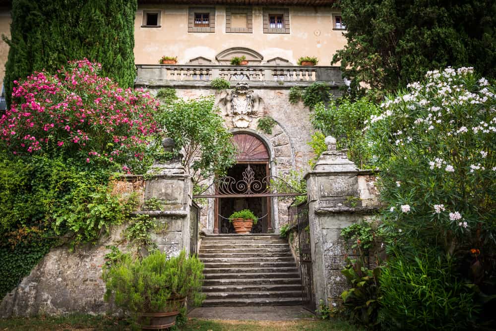 with flowers framing the lovely Castello di Montegufoni, it truly is a fairytale castle in Tuscany
