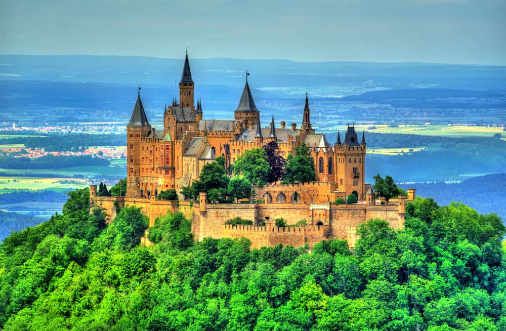 Castles in Germany like Hohenzollern Castle are surrounded by trees in the Swabian Alps