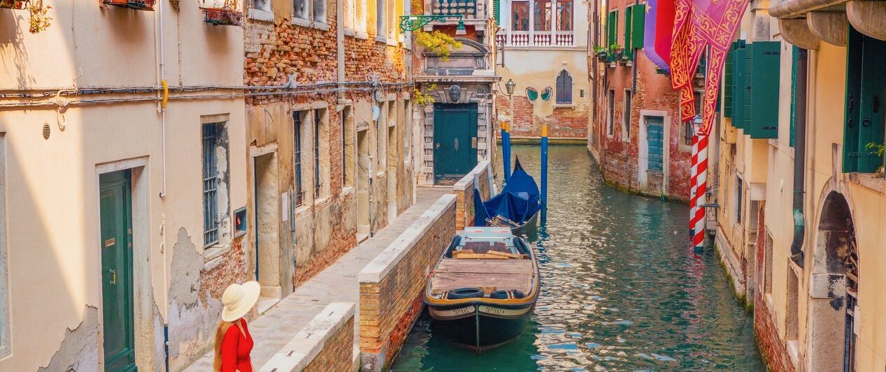 a girl in red dress overlooking the canals in Venice