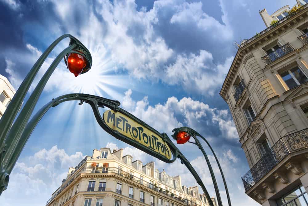 Paris metro station entrance sign with blue sky