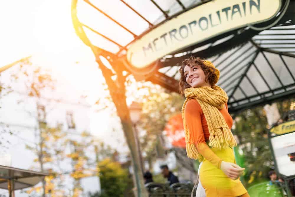 woman walking into one of the many Paris metro stations