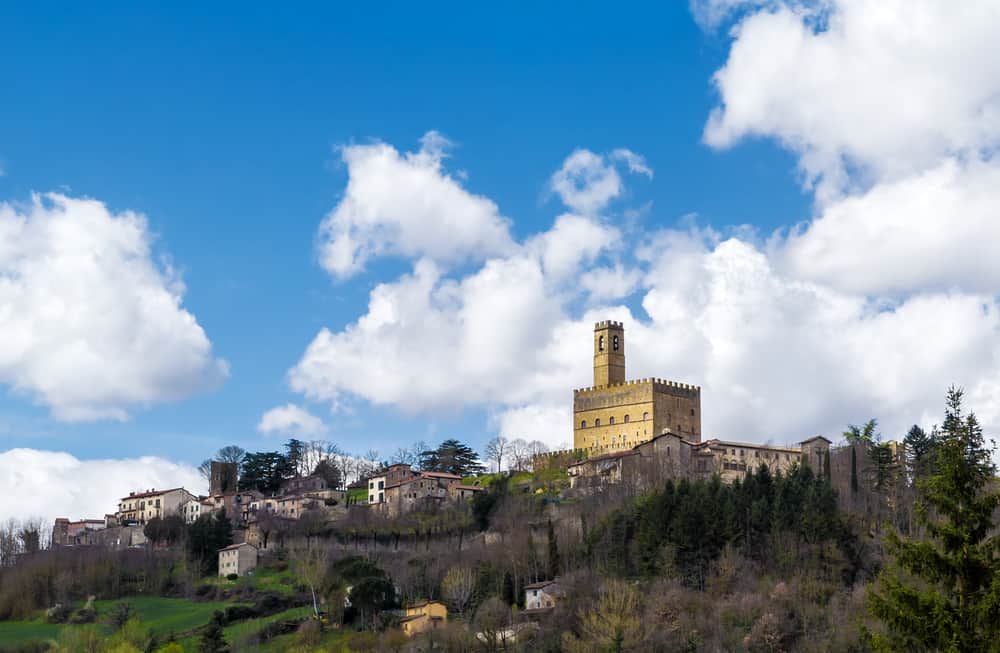 Poppi Castle sits high on a hill with its tower reach for the sky.