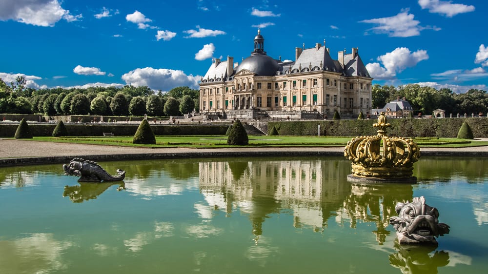 The beautiful castle in France Chateau Vaux le Vicomte is reflected in a pond