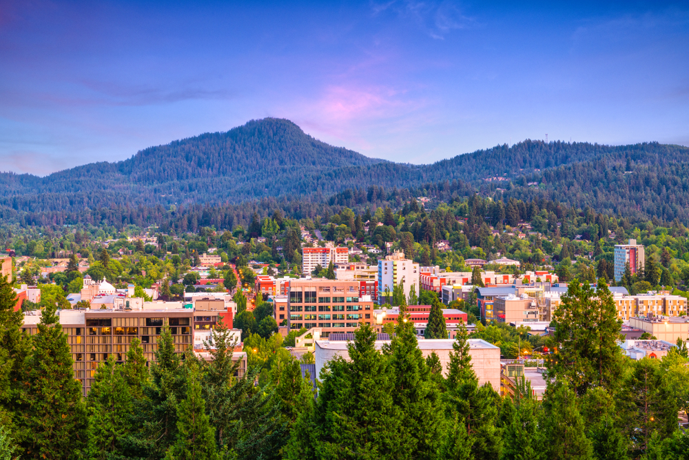 Purple dusk falling over the city of Eugene, Oregon, in the valley with mountains around it.