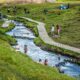 many people bathing in the river at Reykjadalur Hot Springs