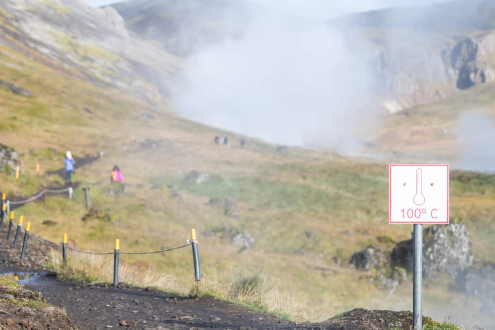signs indicate water too hot to touch along Reykjadalur Hot Springs hike