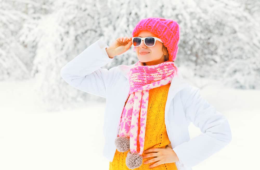 girl wearing sunglasses from her winter packing list