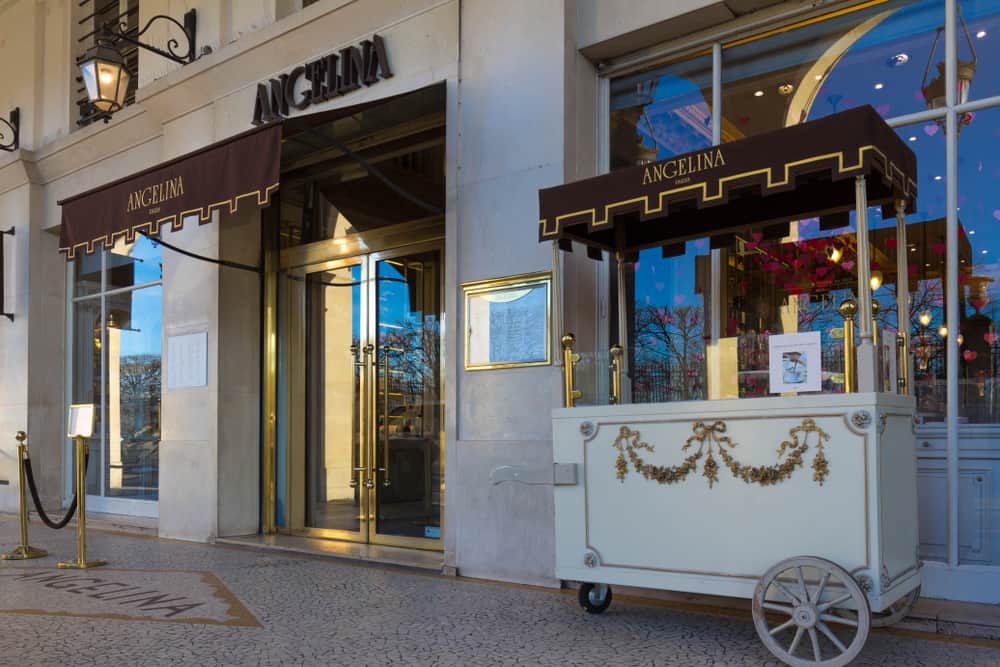 The front entrance of Angelina Paris including a trolley
