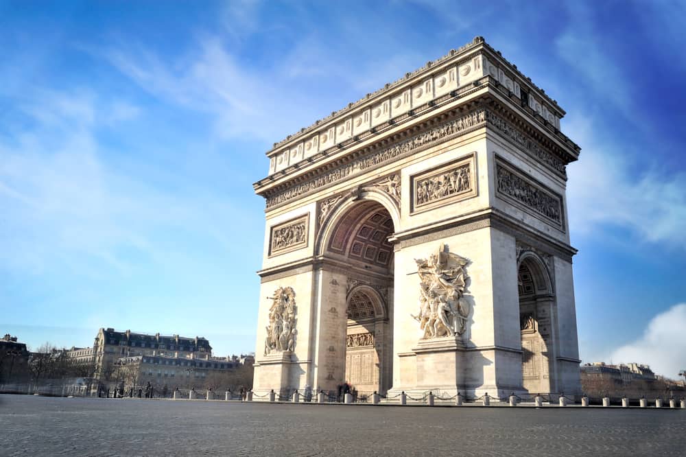 View of the Arc de Triomphe set against a blue sky, Paris in a Day