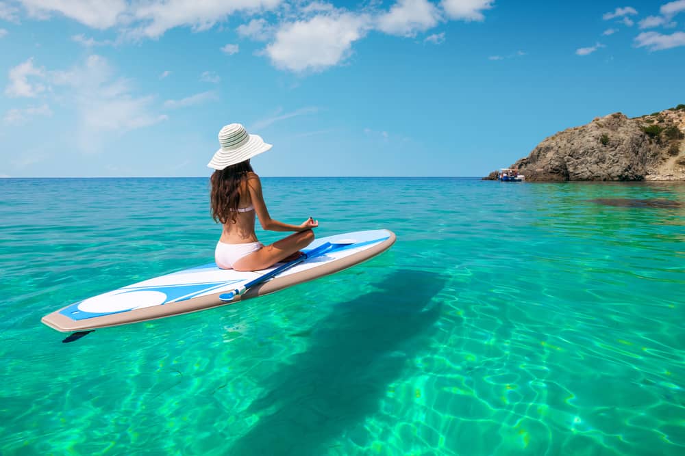 When planning your Hawaii packing list, waterproof cases are a must so you can do water adventures like this young woman and document your experience! 