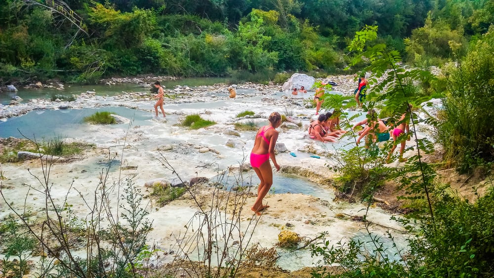 Visitors enjoy the natural and free hot springs in Tuscany!