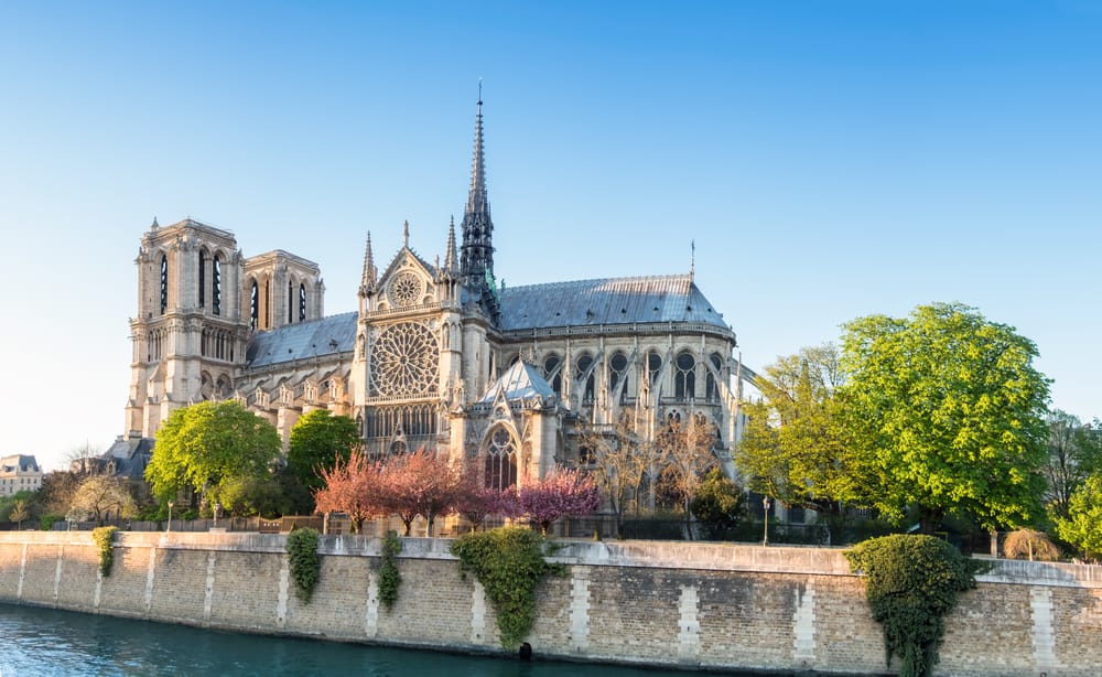 view of Notre Dame Cathedral in spring from across the Seine River