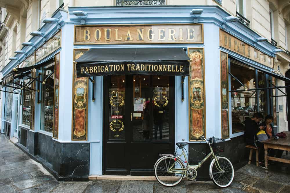 exterior of blue Parisian cafe with bike