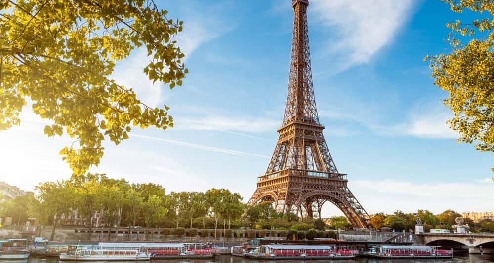 View of the Eiffel Tower with the Seine and riverboats