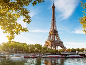 View of the Eiffel Tower with the Seine and riverboats