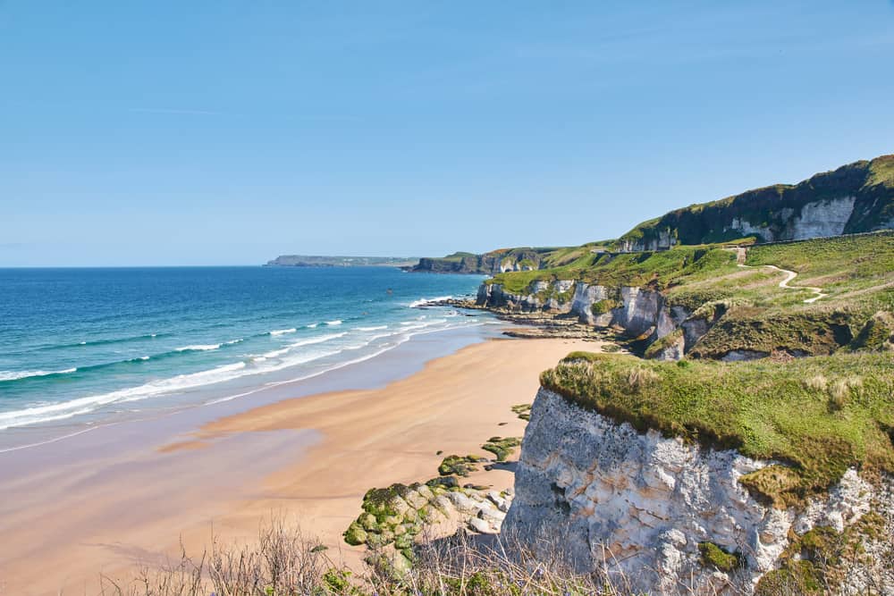 white rocks beach blue water and golden sand