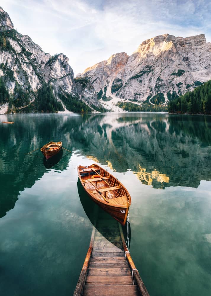 Boats on a blue lake in the Dolomites in Italy