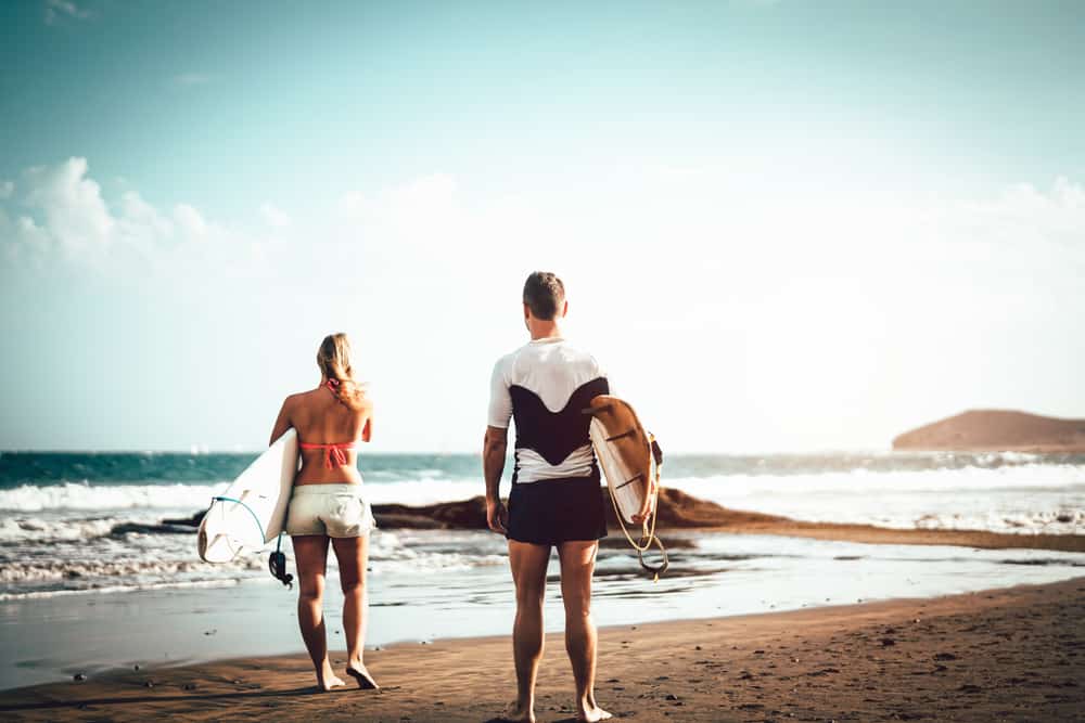 Photo of a Couple Going Surfing in the Maldives