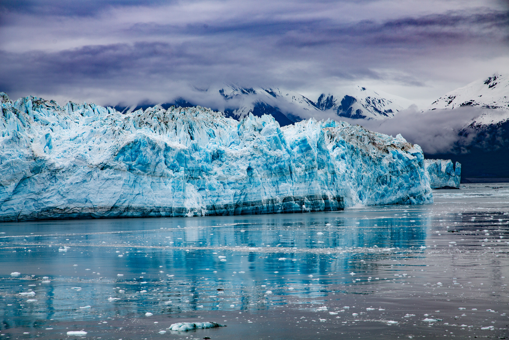 Glacier in Seward with blue ice and a dramatic sky.