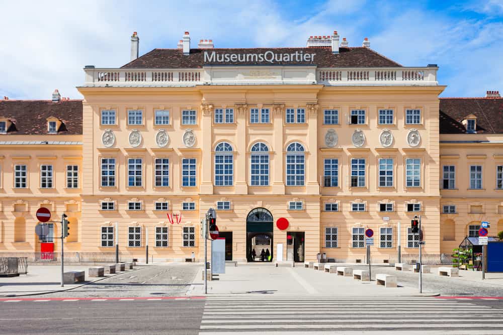 Front of the pink-orange colored MuseumsQuartier building in Neubau.