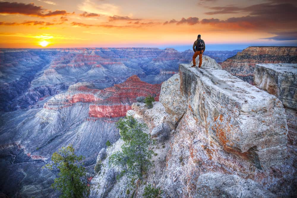 a hiker looks at the views on one of the Grand Canyon hikes