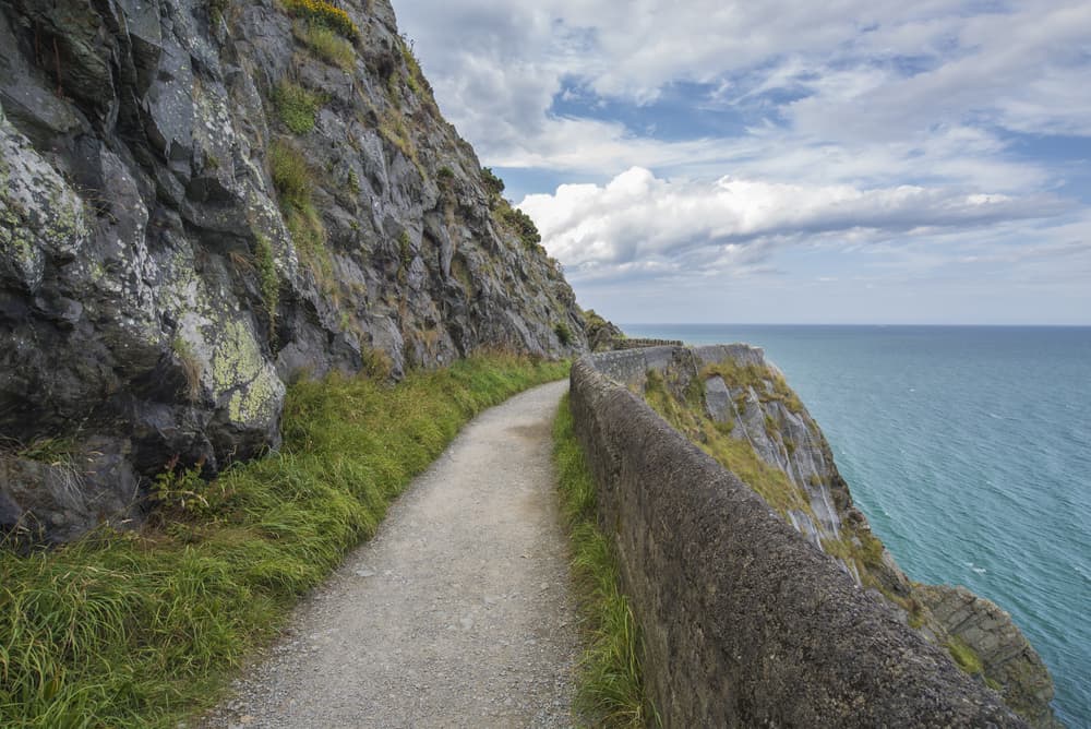 one of the unique hikes in Ireland Bray to Greystones has a path carved into the cliffside along the water following the same route as the train