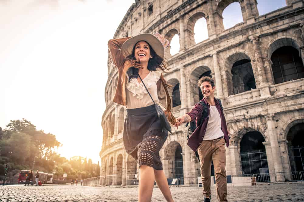 couple on their honeymoon in Italy running in sunset