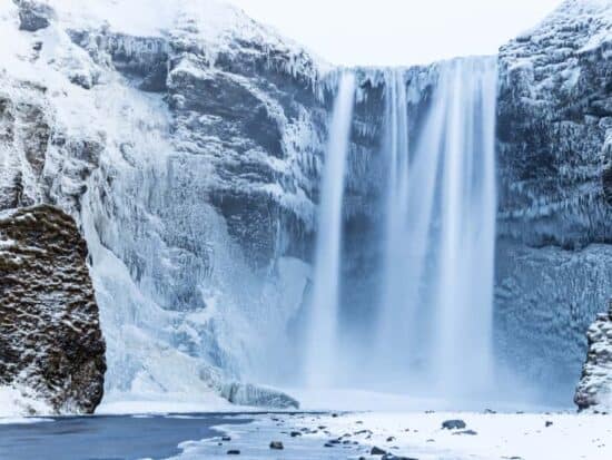 Skogafoss Waterfall with snow in Iceland in January