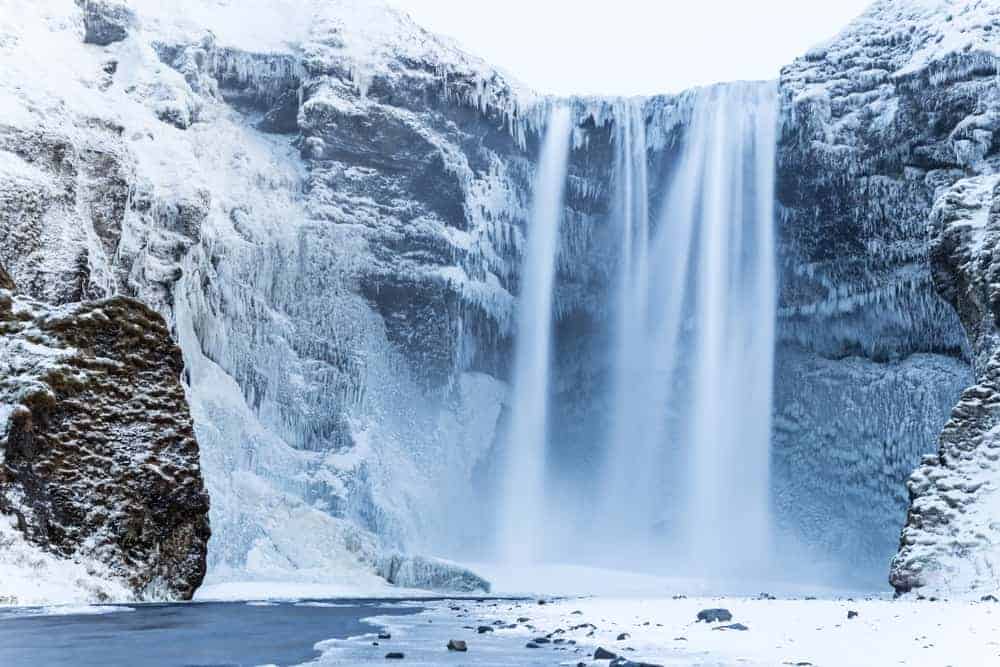 Skogafoss Waterfall with snow in Iceland in January